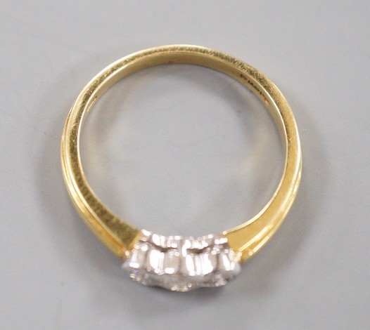 A modern 18ct gold and collet set three stone diamond ring, size P, gross weight 3.6 grams